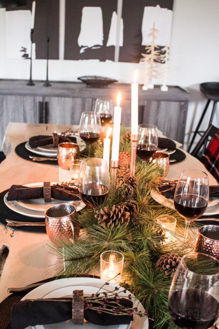 Combine rustic natural elements and a little Christmas glam to create this sleek Rustic Chic Christmas Table with black and white dishes and pops of greens.