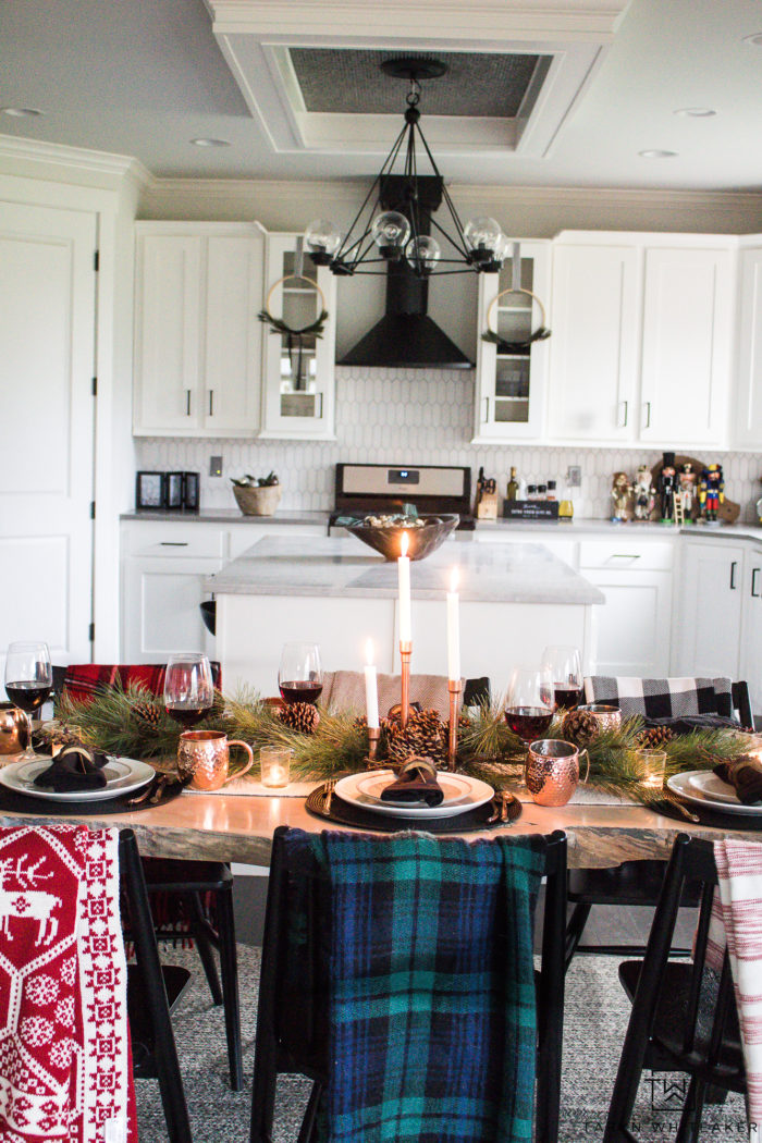 Combine rustic natural elements and a little Christmas glam to create this sleek Rustic Chic Christmas Table with black and white dishes and pops of greens.