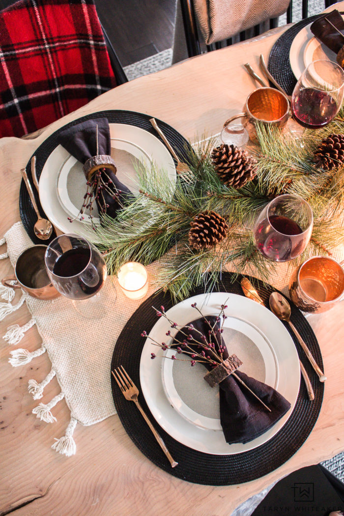 Combine rustic natural elements and a little Christmas glam to create this sleek Rustic Chic Christmas Table with black and white dishes and pops of greens.