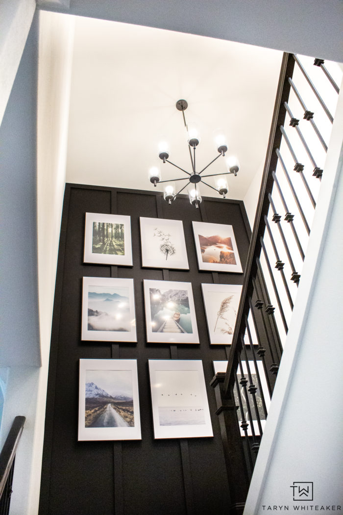 This custom gallery wall took a builder grade staircase into a custom modern look with a bold accent wall and oversized gallery wall. 