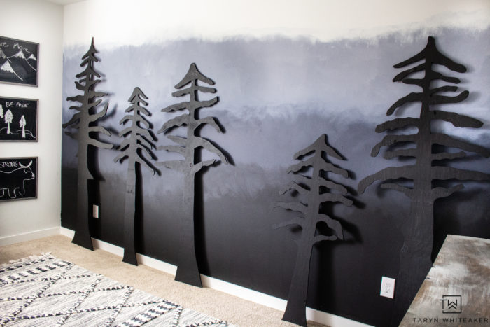 Learn how to easily create your own DIY Forest Accent Wall that will make a huge impact in your space! Cut these trees out of plywood using a jigsaw and give them a coat of paint! Full tutorial on the blog.