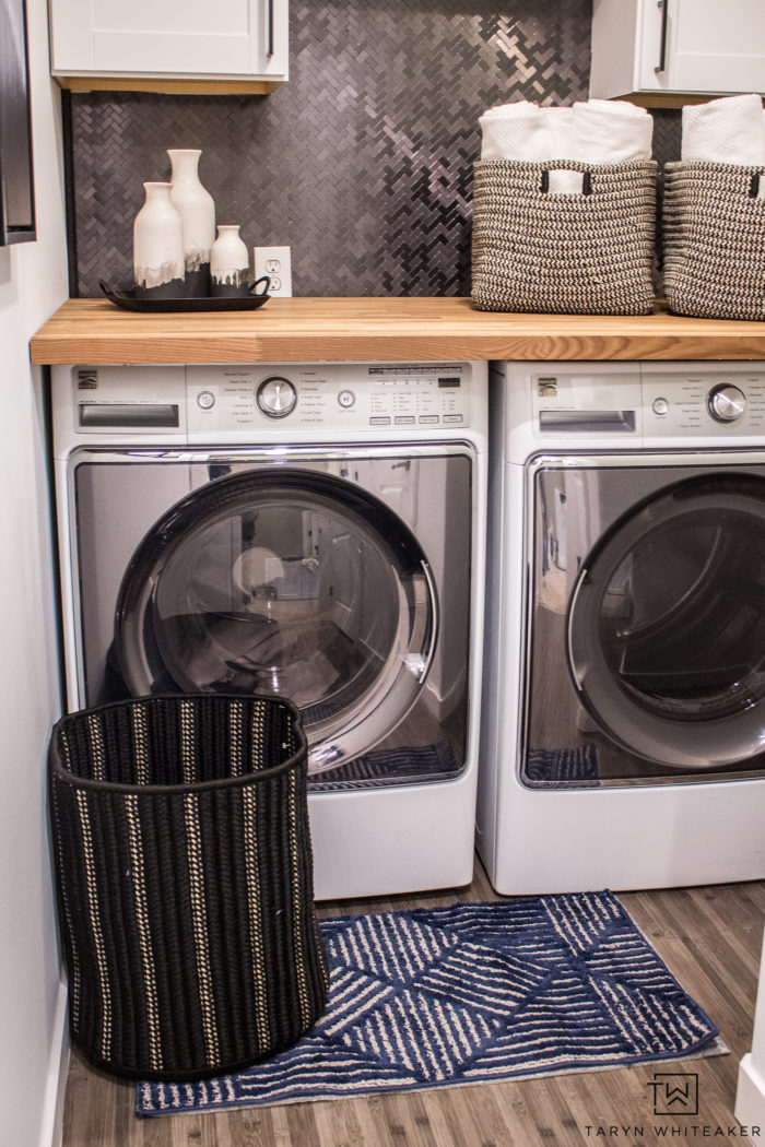 modern farmhouse style laundry room makeover. Love the black and white laundry room decor with wood countertops and fun accessories. 