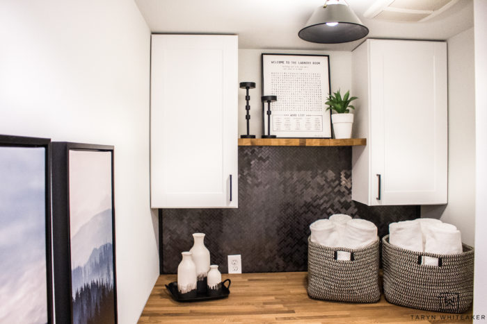 Upgrade your small laundry room by adding cabinets, and decor that is both functional and decorative. 