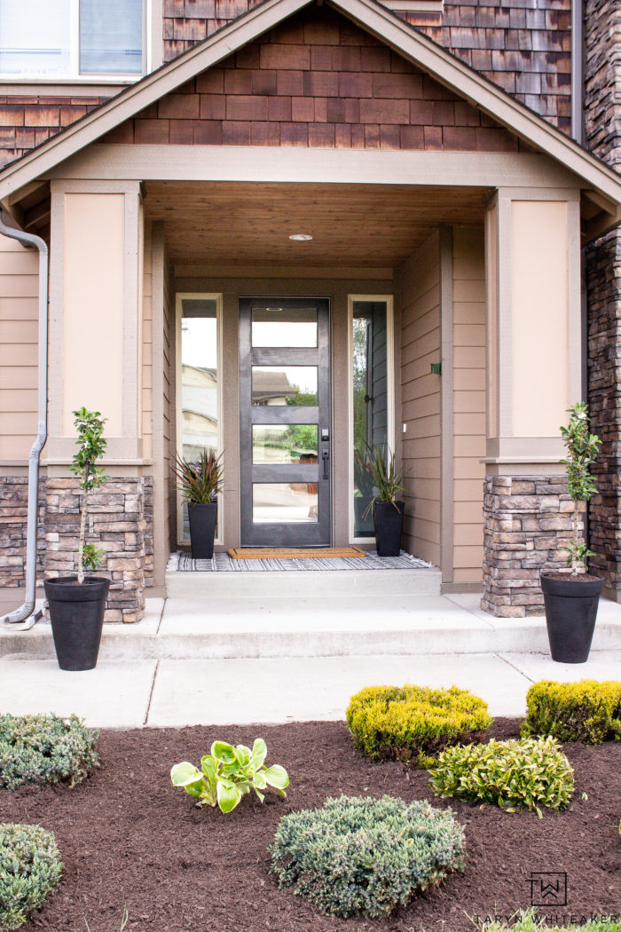 Spruce up your curb appeal with these Summer Porch Updates! Paint your door a bold dark color and plant a few fruit trees! Fresh mulch always makes your landscape pop!