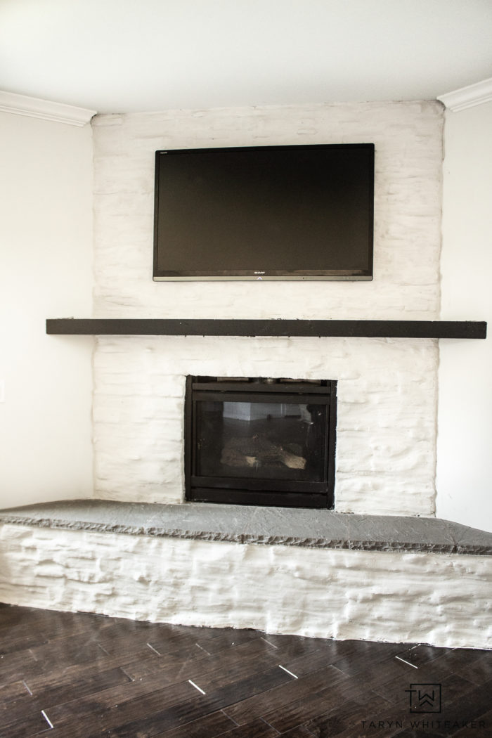 Learn how to brighten up your fireplace with this German Schmear Stone Fireplace Tutorial. Go from dark stone to bright and clean!