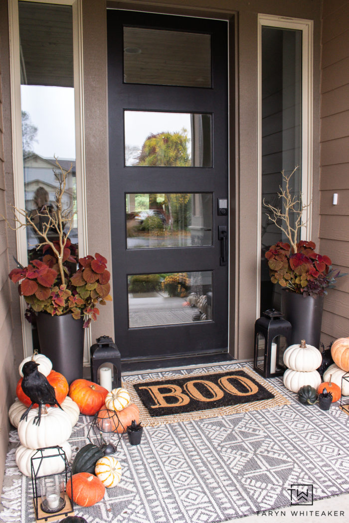 Transition your fall porch with some Halloween Porch Decor by adding black crows, lanterns, braches and boo door mat! 