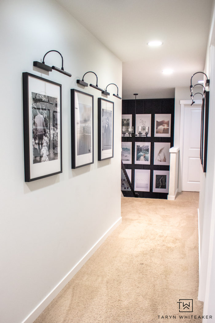 Spruce up your boring hallway with this Black and White Hallway Gallery Wall using personal pictures and wireless sconces!