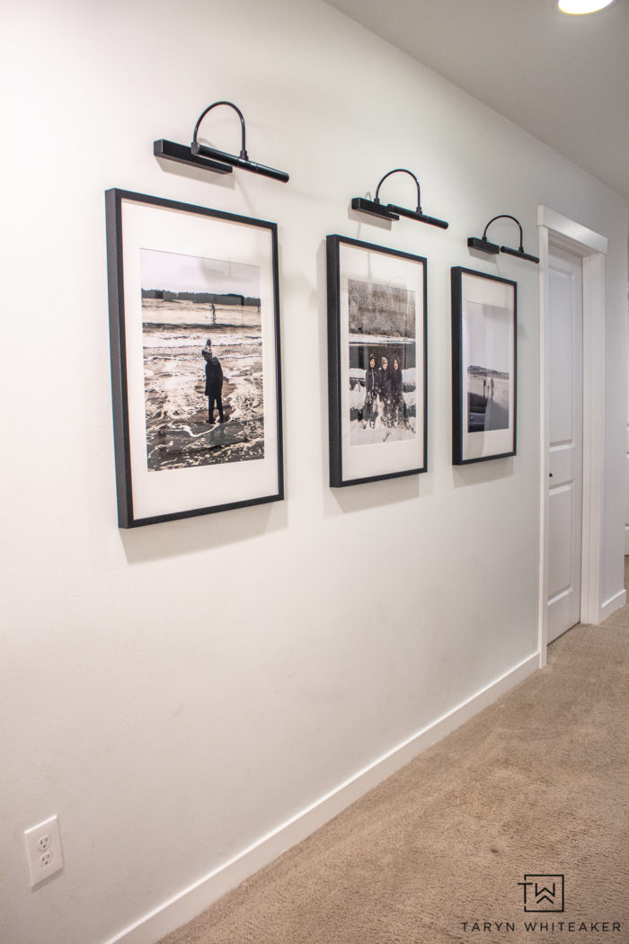 Spruce up your boring hallway with this Black and White Hallway Gallery Wall using personal pictures and wireless sconces!