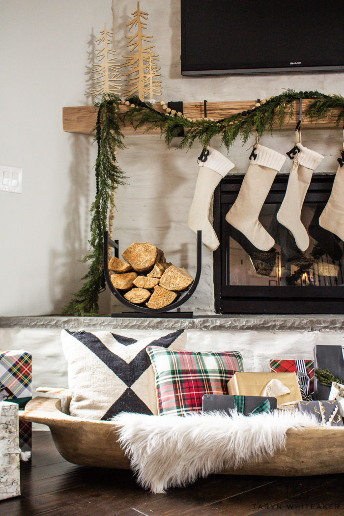 Fill a large vintage dough bowl with presents and pillows to add a new touch to your Christmas decor. 