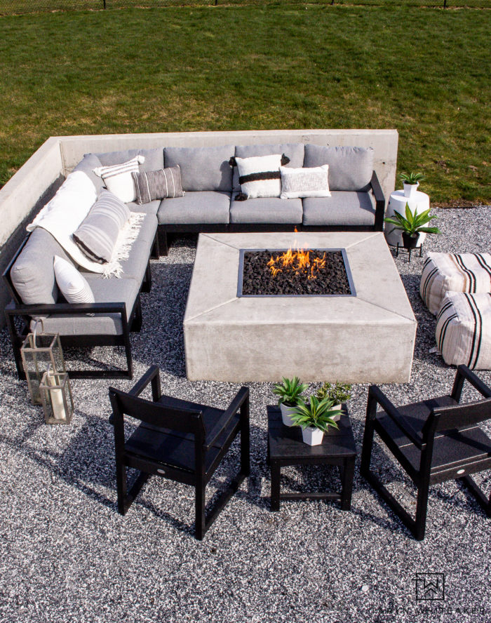 Tour this modern outdoor fire pit seating area with concrete square fire pit and sectional sofa. 