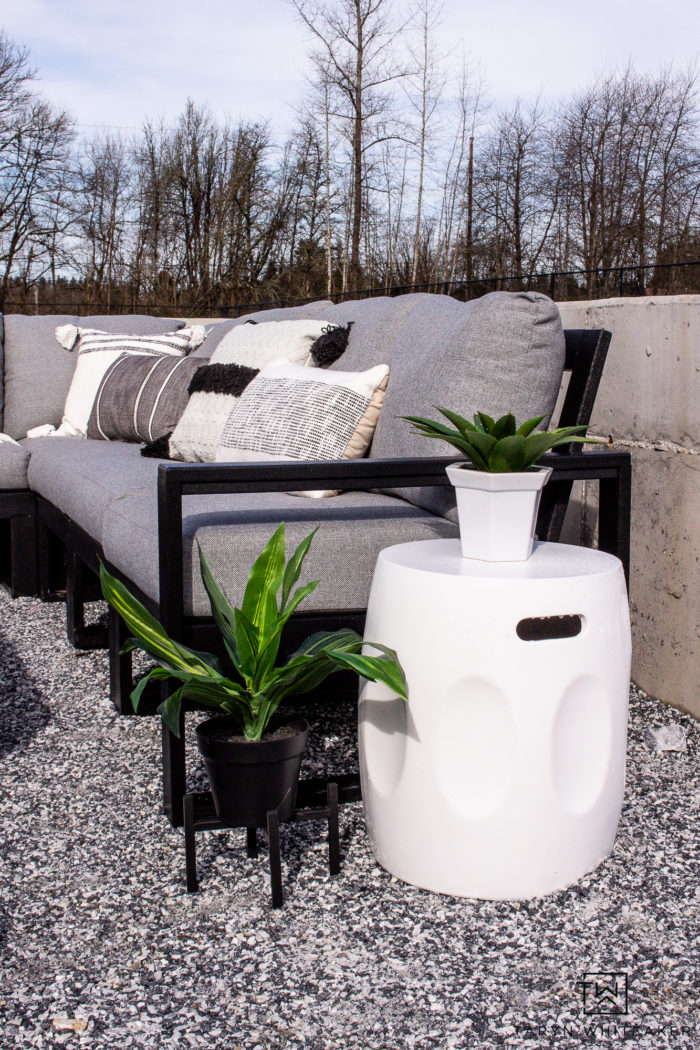 Black and white modern outdoor furniture with greenery. 