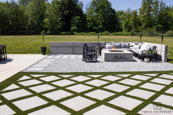 Backyard landscape design with concrete fire pit and modern outdoor space complete with grid style turf. 