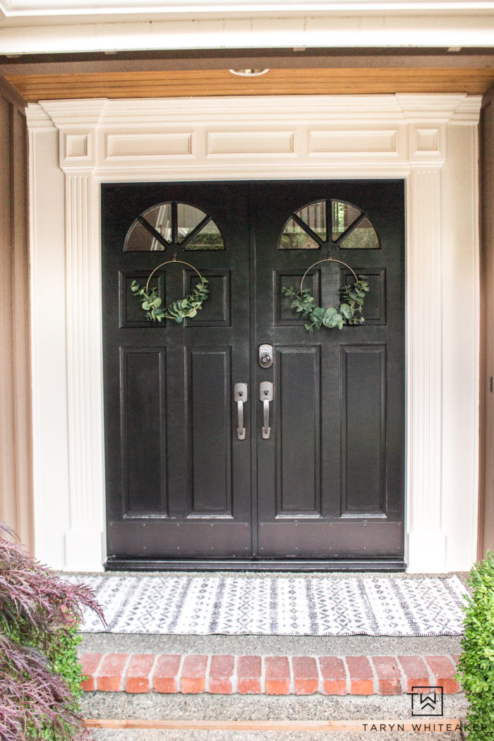 Black front door with white trim and farmhouse accents 