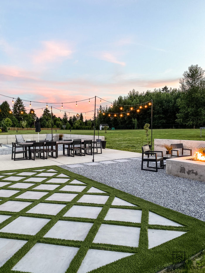 modern backyard design with diagonal turf and pavers with large outdoor table and modern square firepit  