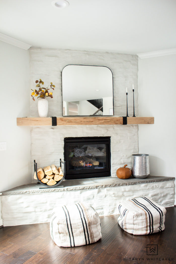 Fall decor does't have to be cluttered. Tour this simple modern fall mantel with warm earth tones and neutral textures. 