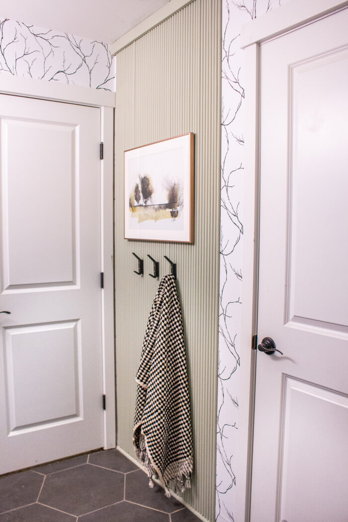 fluted accent wall painted in October Mist by Benjamin Moore! Perfect back drop for a towel hanging station.