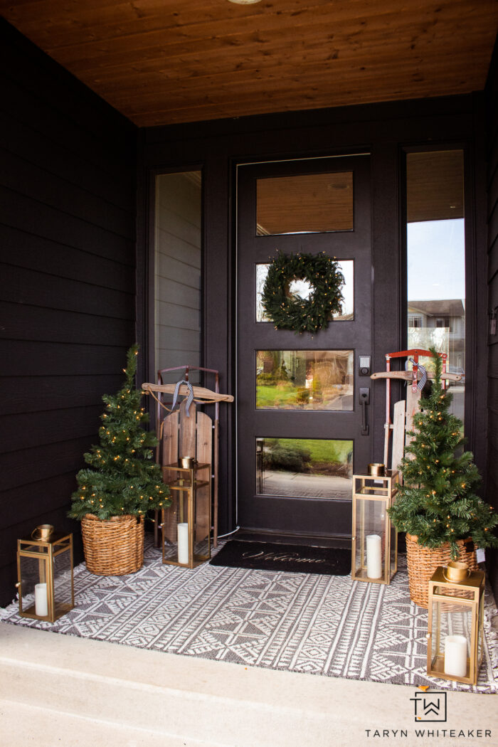 Get the look of this Classic Holiday Porch with greenery, vintage sleds and brass lanterns that add a glow. 