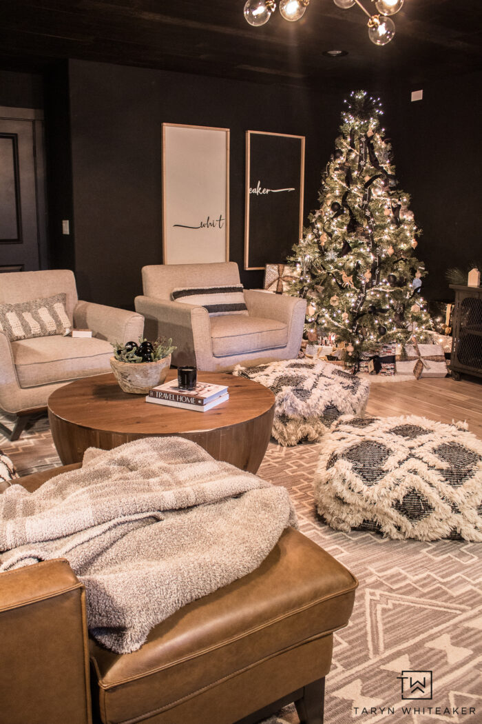 Neutral Movie room with lots of soft textures and black walls. Styled for Christmas with a black and white Christmas tree. 