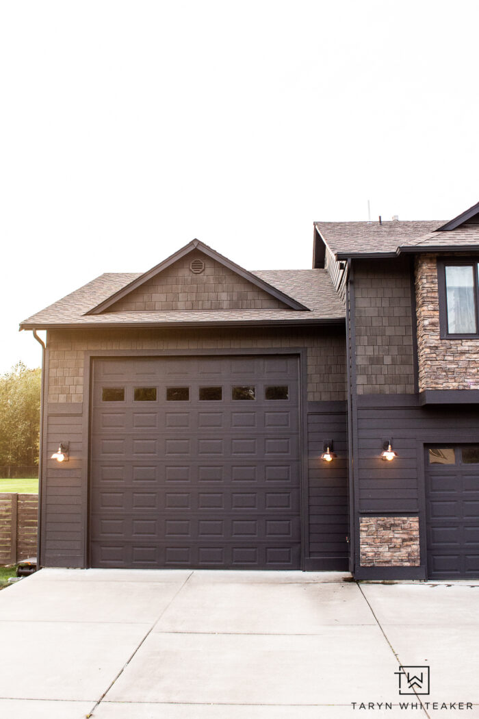 Dark Home Exterior Makeover with stacked stone and copper lights