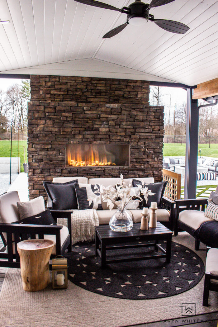 Tour this Covered Outdoor Living Space Decor with touches of spring. New neutral outdoor pillows with cozy spring accents.