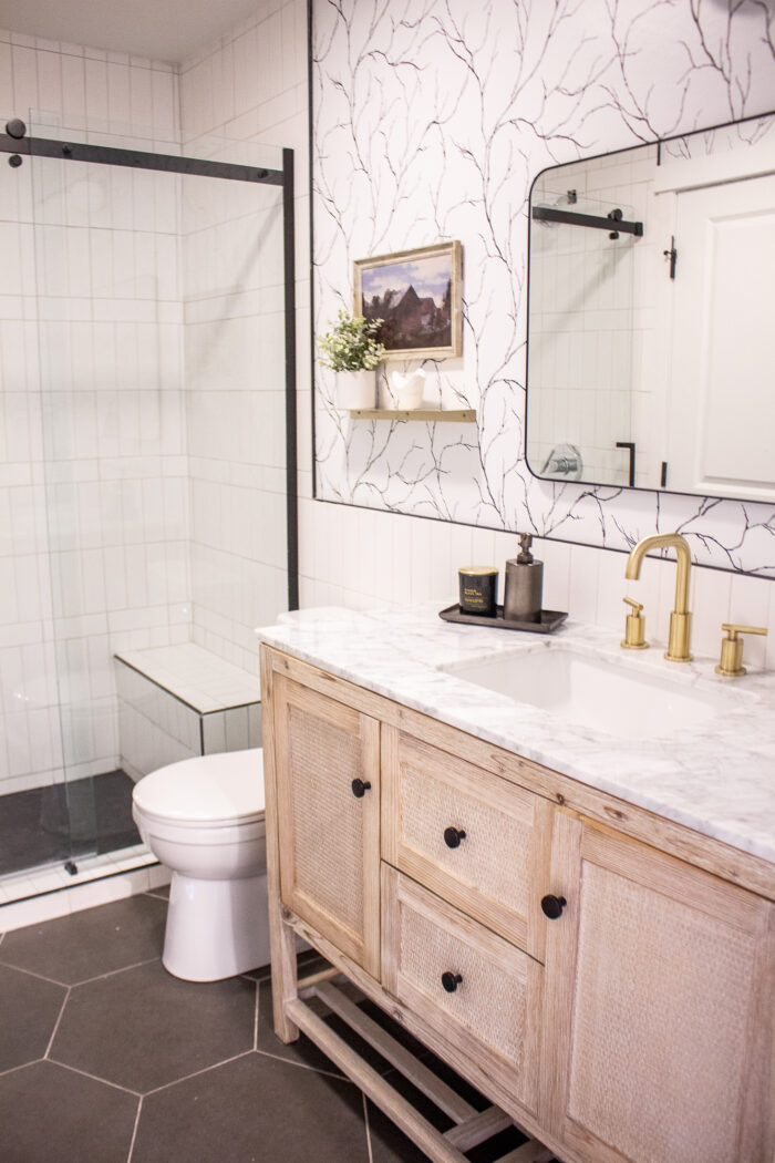 Tour this DIY friendly Stylish Black and White Bathroom Renovation that includes floor to ceiling tile, unique wood vanity and brass. 