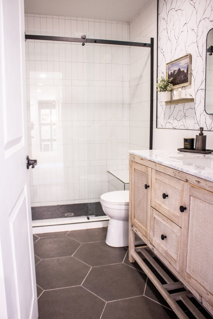 Hexagon bathroom tile and white subway shower with basket weave pattern. 