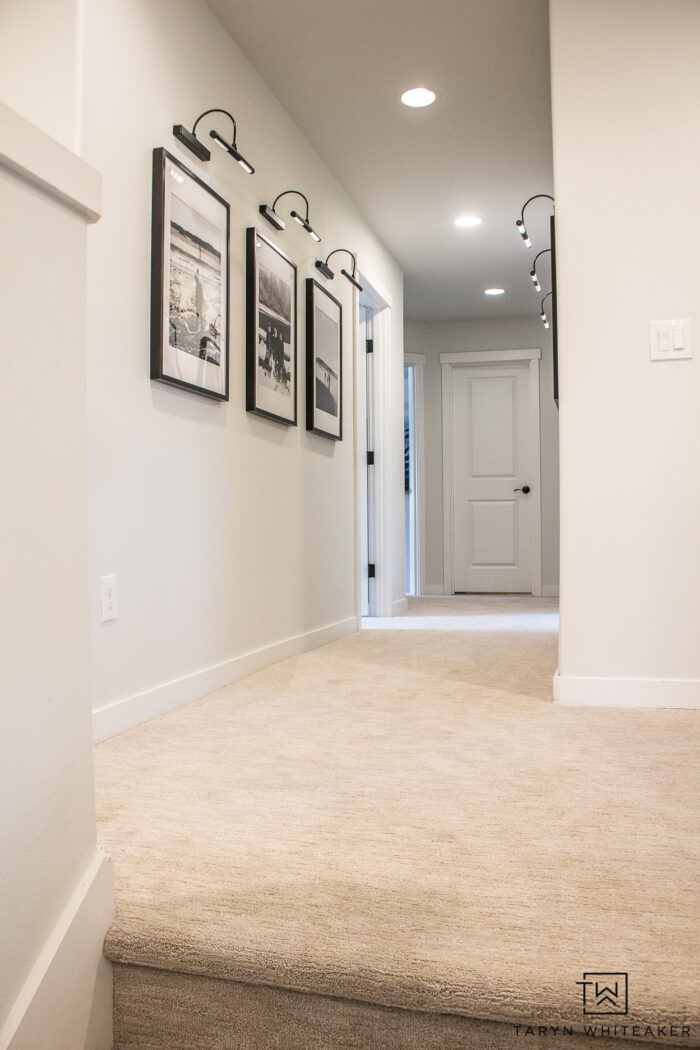 black and white hallway with neutral patterned carpet