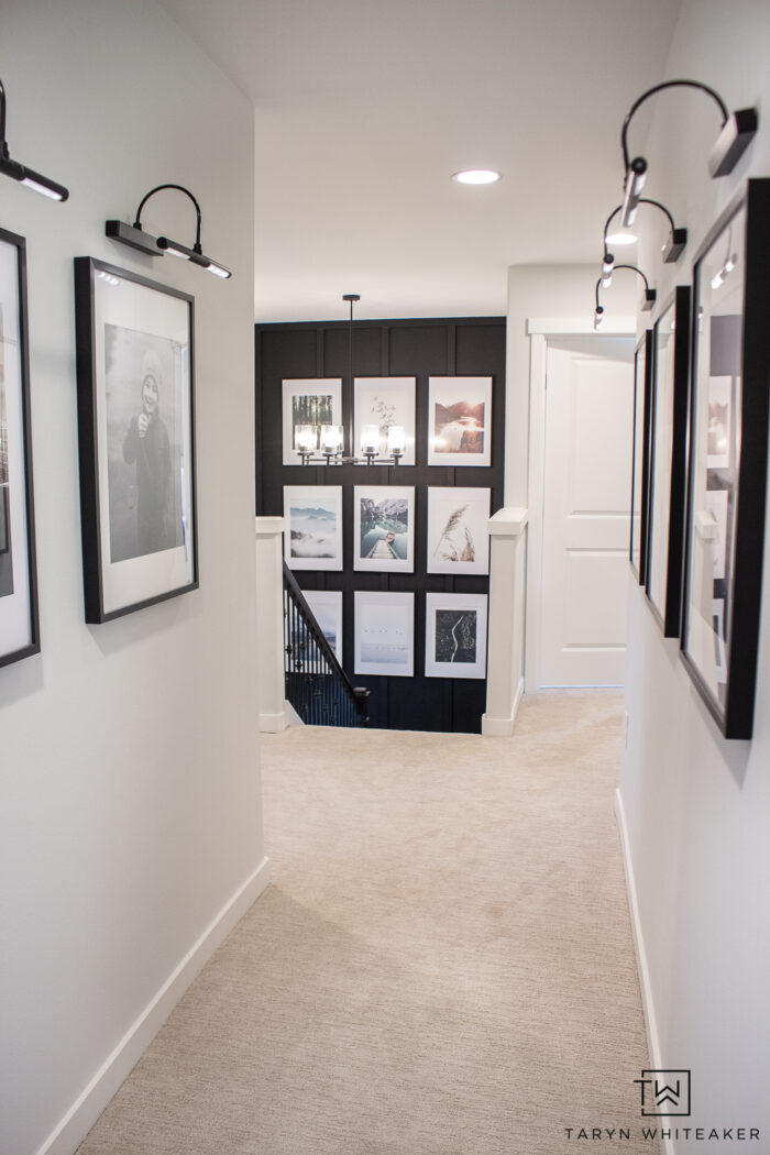 white walls with black and white artwork for a casual modern look in the hallway. 