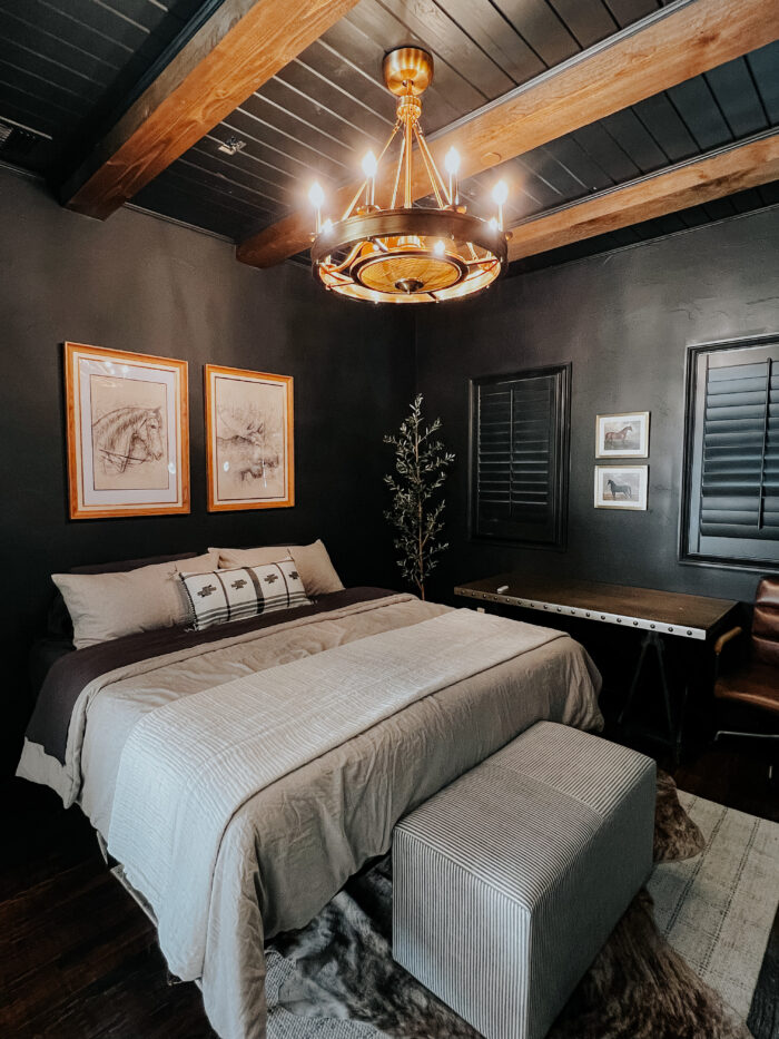 Moody guest room with tongue and groove ceiling painted in a Black Magic.