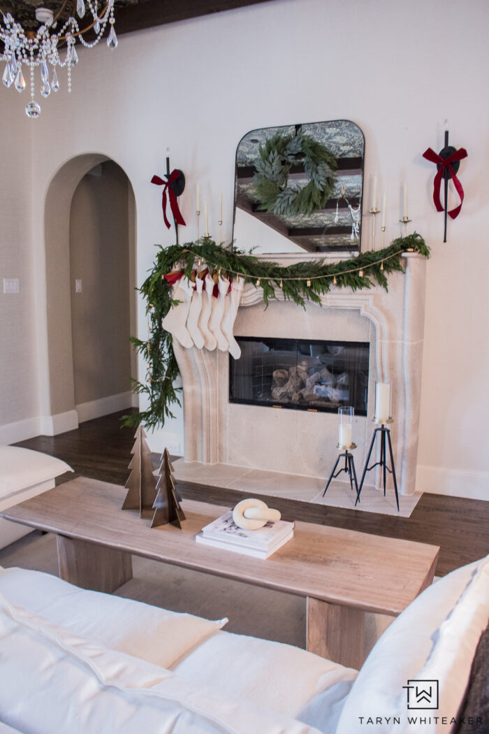 Get the look of this European Inspired Christmas Mantel by twisting multiple garlands together and adding brass candles with pops of red. 