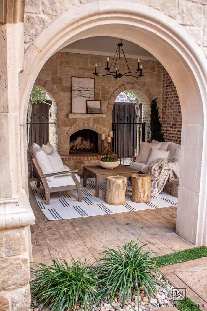 Modern European home exterior with stone, brick and outdoor fireplace seating area off the court yard. 