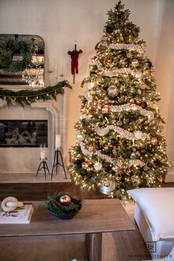 Tour this Classic Christmas Tree and Mantel with neutral Christmas decor, lush greenery and pops of red. Sharing all sources. 