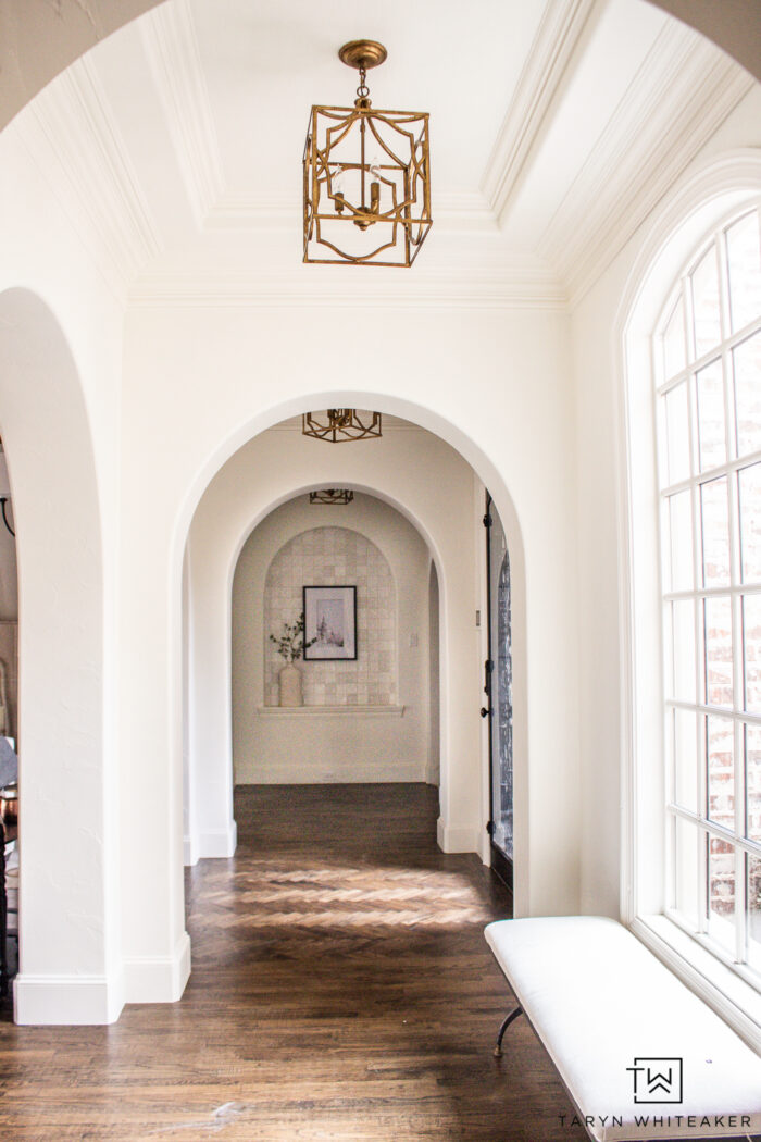 This arched hallway design is stunning, elegant and timeless. See the before and after pics of a fresh coat of paint and new tile work. 
