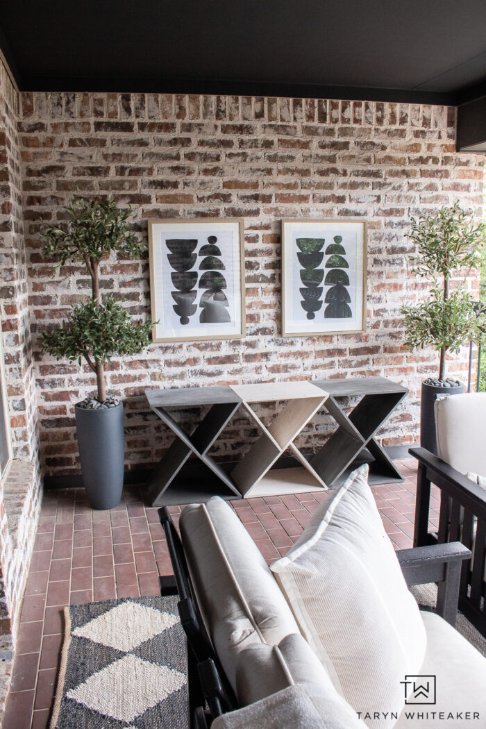 Brick patio made into a modern space with Urbane Bronze door and trim, painted French doors, black POLYWOOD furniture, rustic coffee table and a mixture of both modern and vintage elements. 