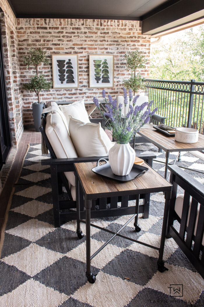 Brick patio made into a modern space with Urbane Bronze door and trim, painted French doors, black POLYWOOD furniture, rustic coffee table and a mixture of both modern and vintage elements. 