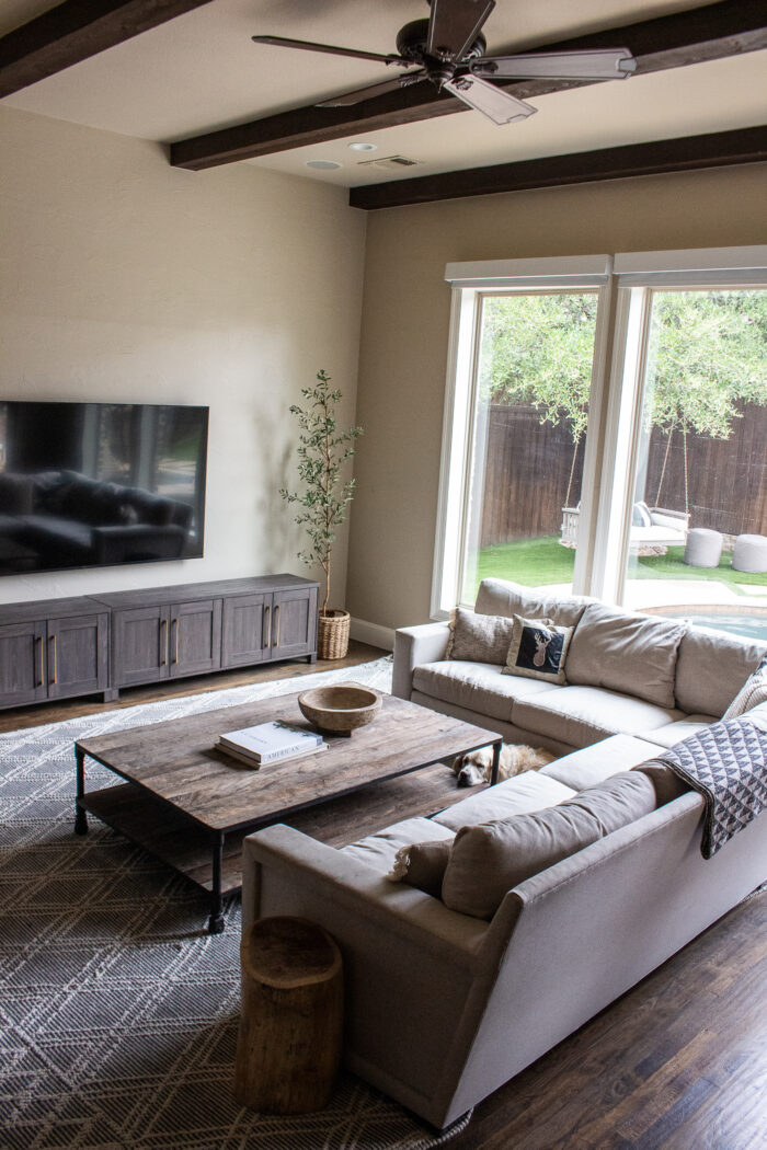 neutral rustic contemporary family room with mixture of black, cream and wood tones 