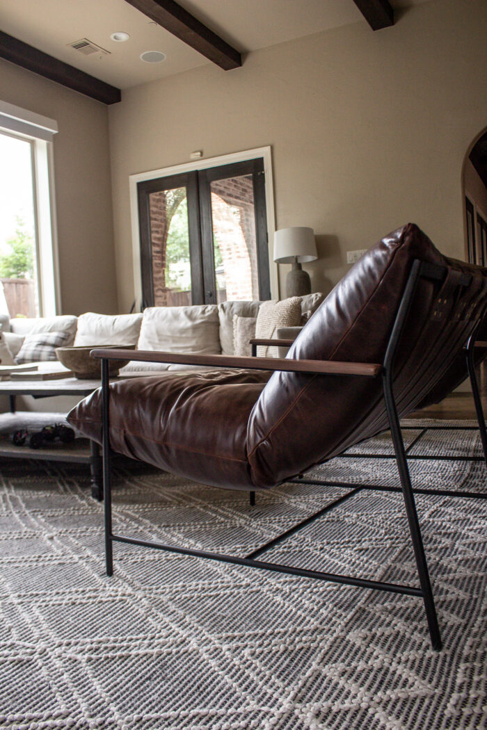 Organic modern family room design with casual elegance. Deep rich browns and neutral colors and texture.