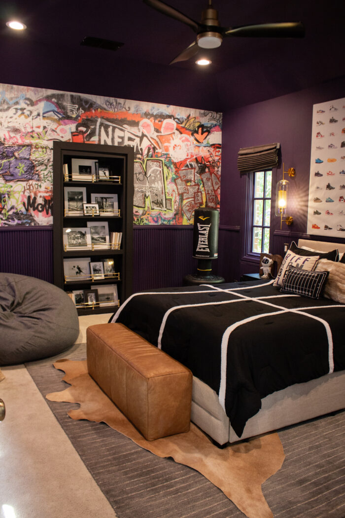 Bold Teen boy sports themed bedroom with dark purple walls and modern design