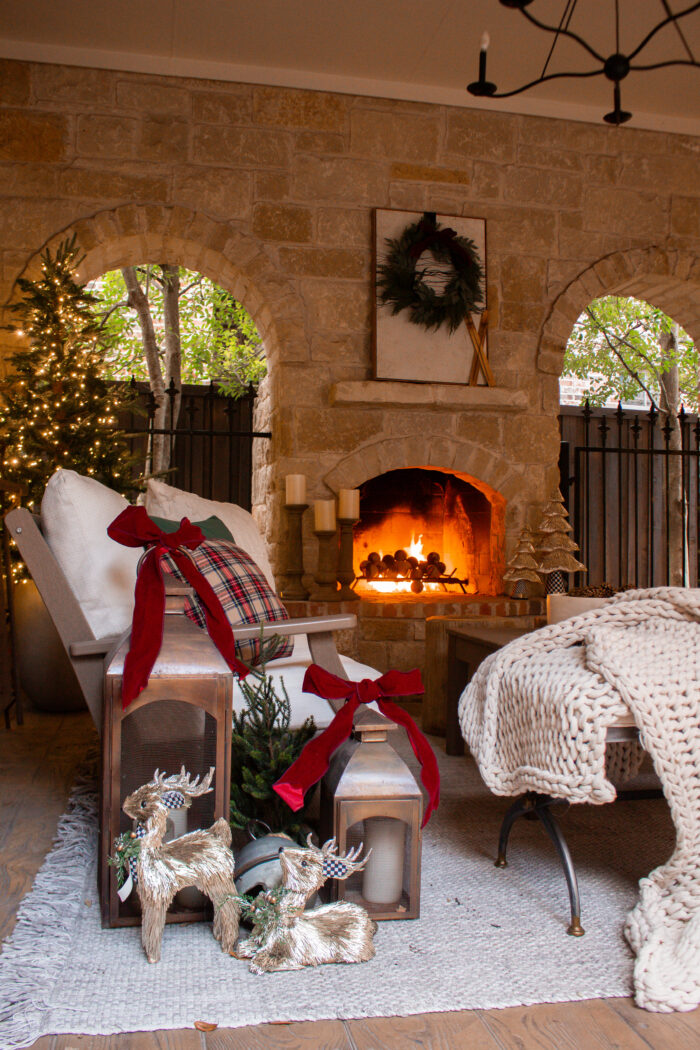 Take a tour of this Plaid Outdoor Christmas Porch Decor with neutral outdoor furniture paired with deep green, red and plaid holiday decor