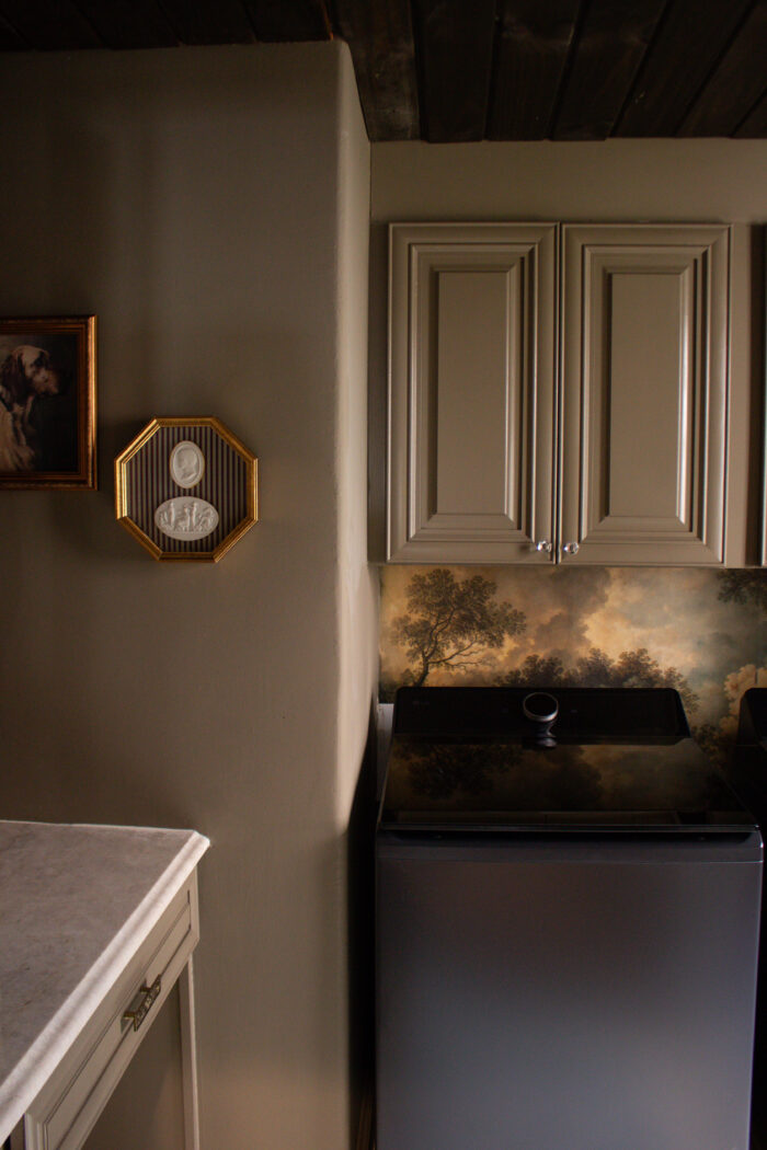 Moody vintage laundry room makeover using BM Cromwall Gray color drench with antique and gold accents. 