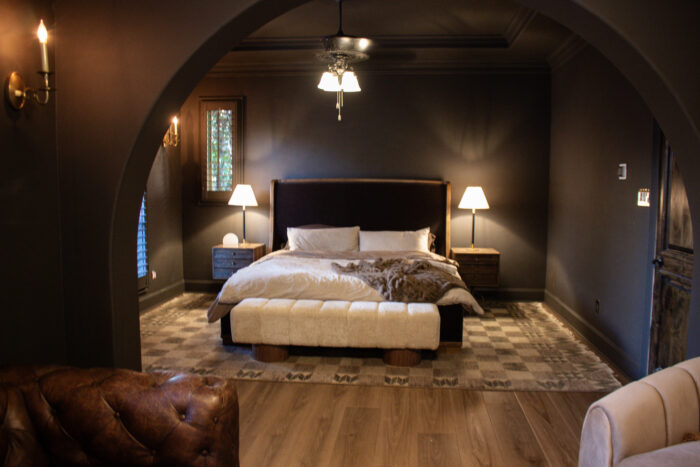 Rustic luxury bedroom design with chocolate brown walls and brown leather accents
