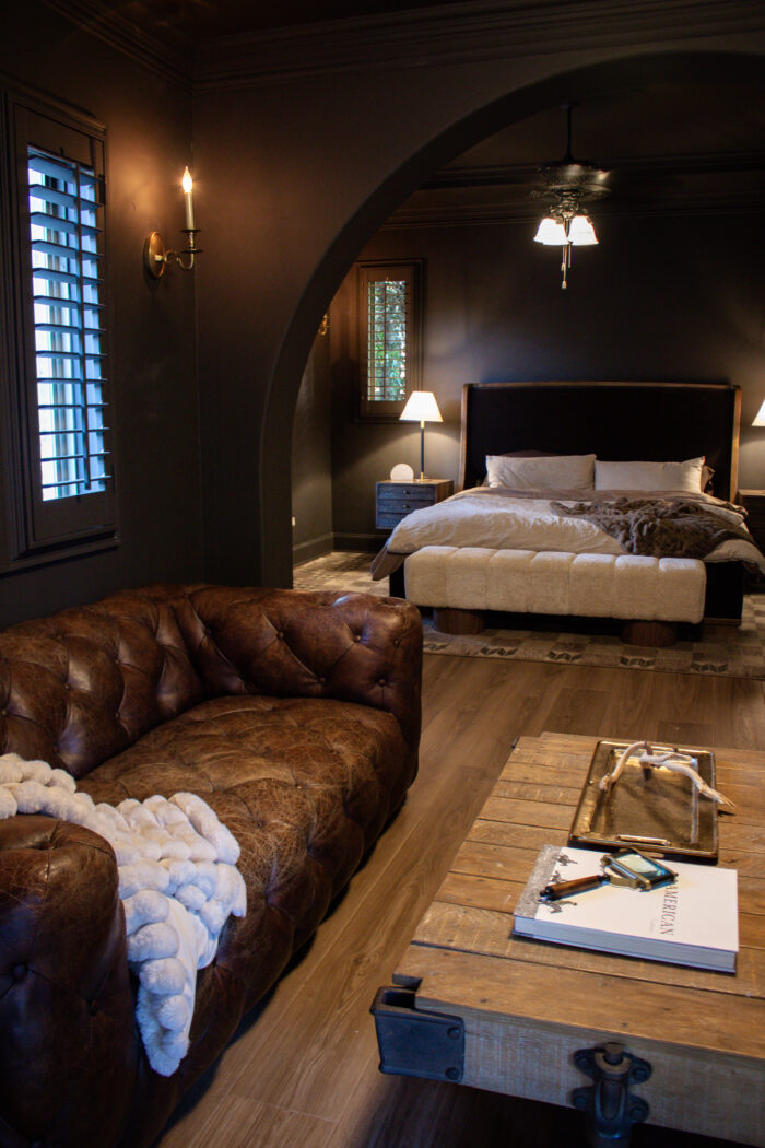 Rustic luxury bedroom design with chocolate brown walls and brown leather accents