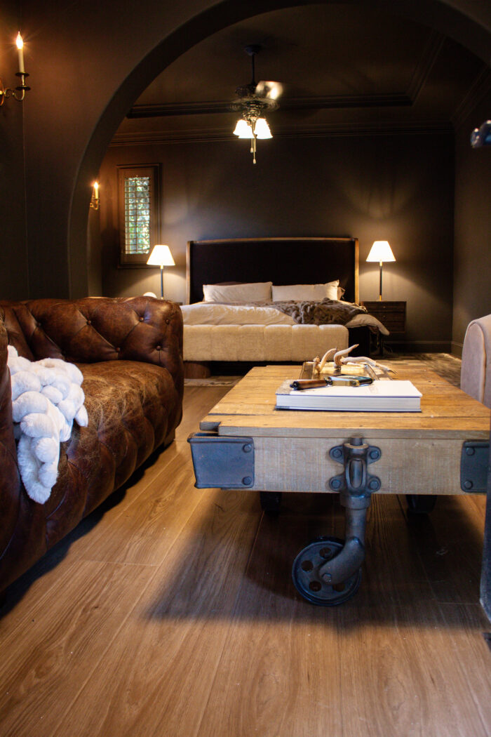 Rustic luxury bedroom design with chocolate brown walls and brown leather accents